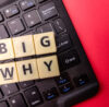 Keyboard and toys word with the word BIG WHY. Business concept
