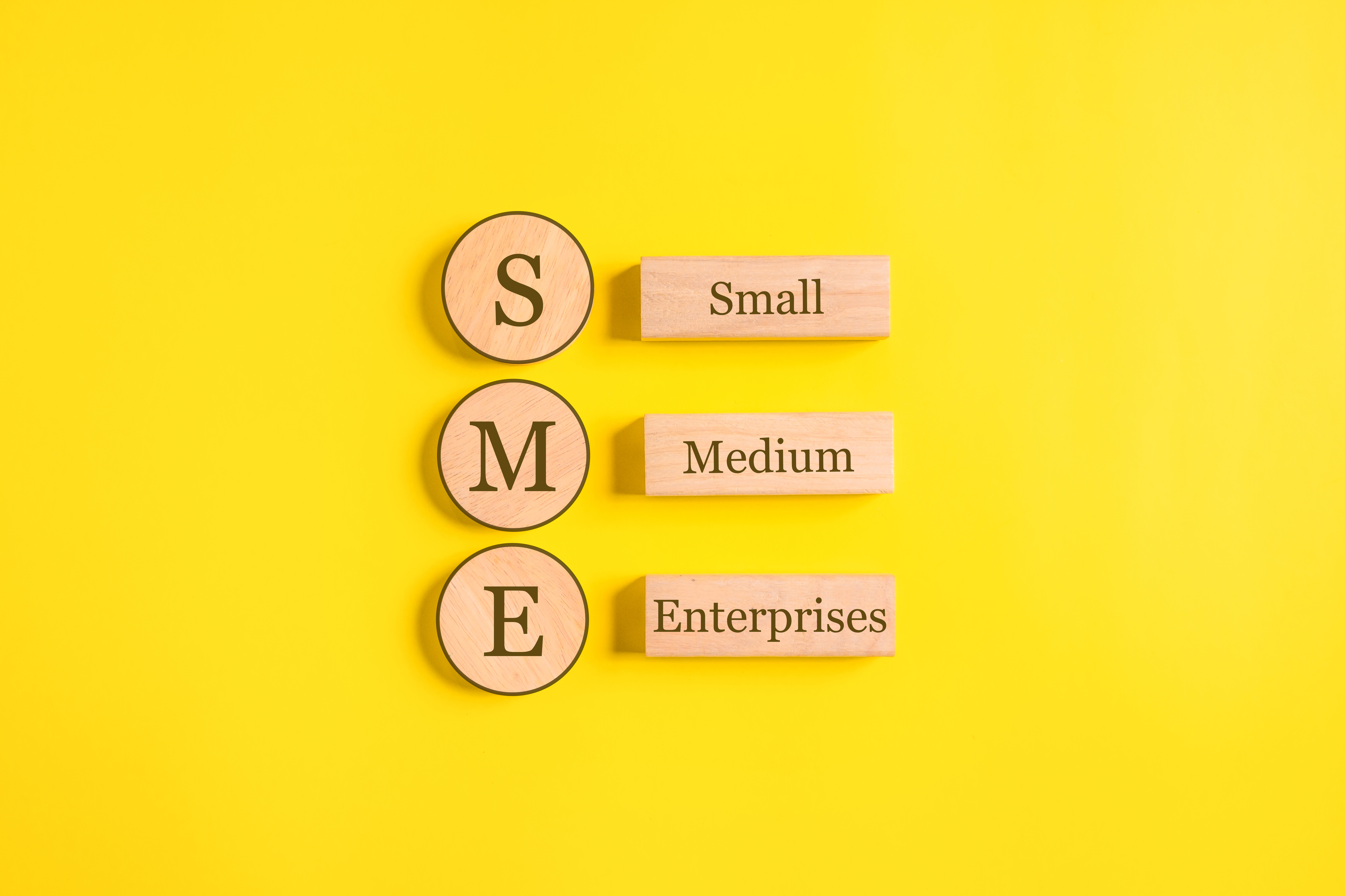 SME, Small Medium Enterprises word on wooden cubes with copy space, Start up small business
