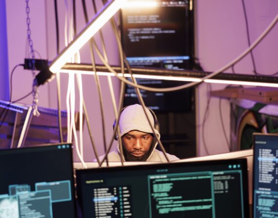 Hacker in headphones programming malware