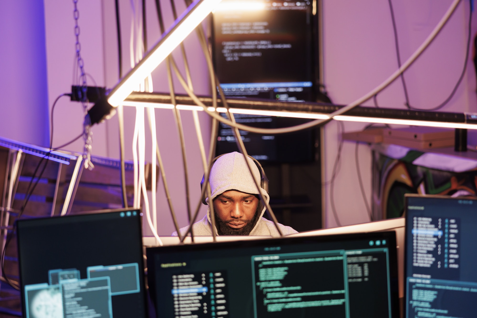 Hacker in headphones programming malware